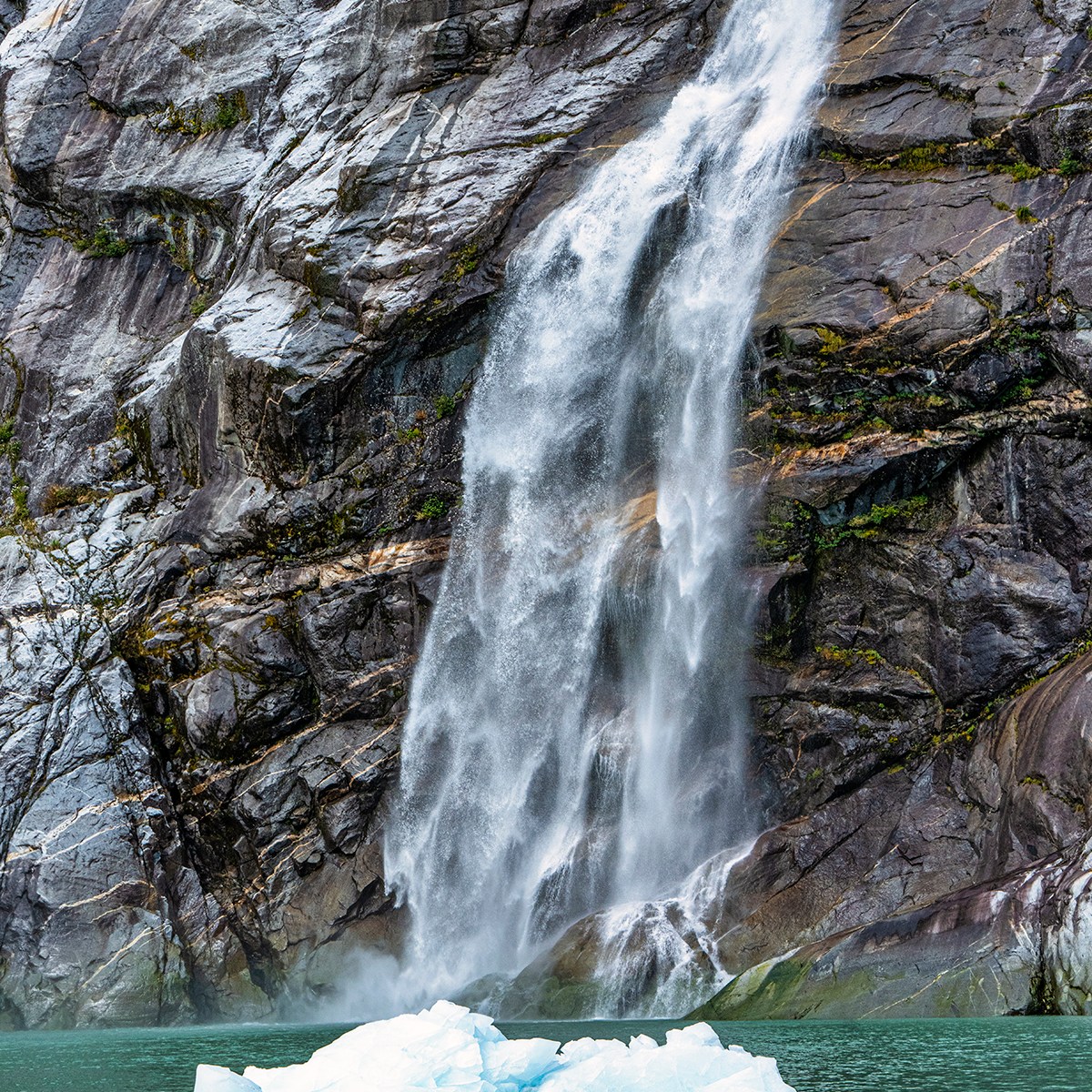 a large waterfall over some water