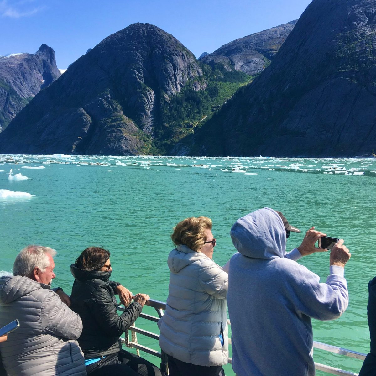 a group of people standing on top of a mountain