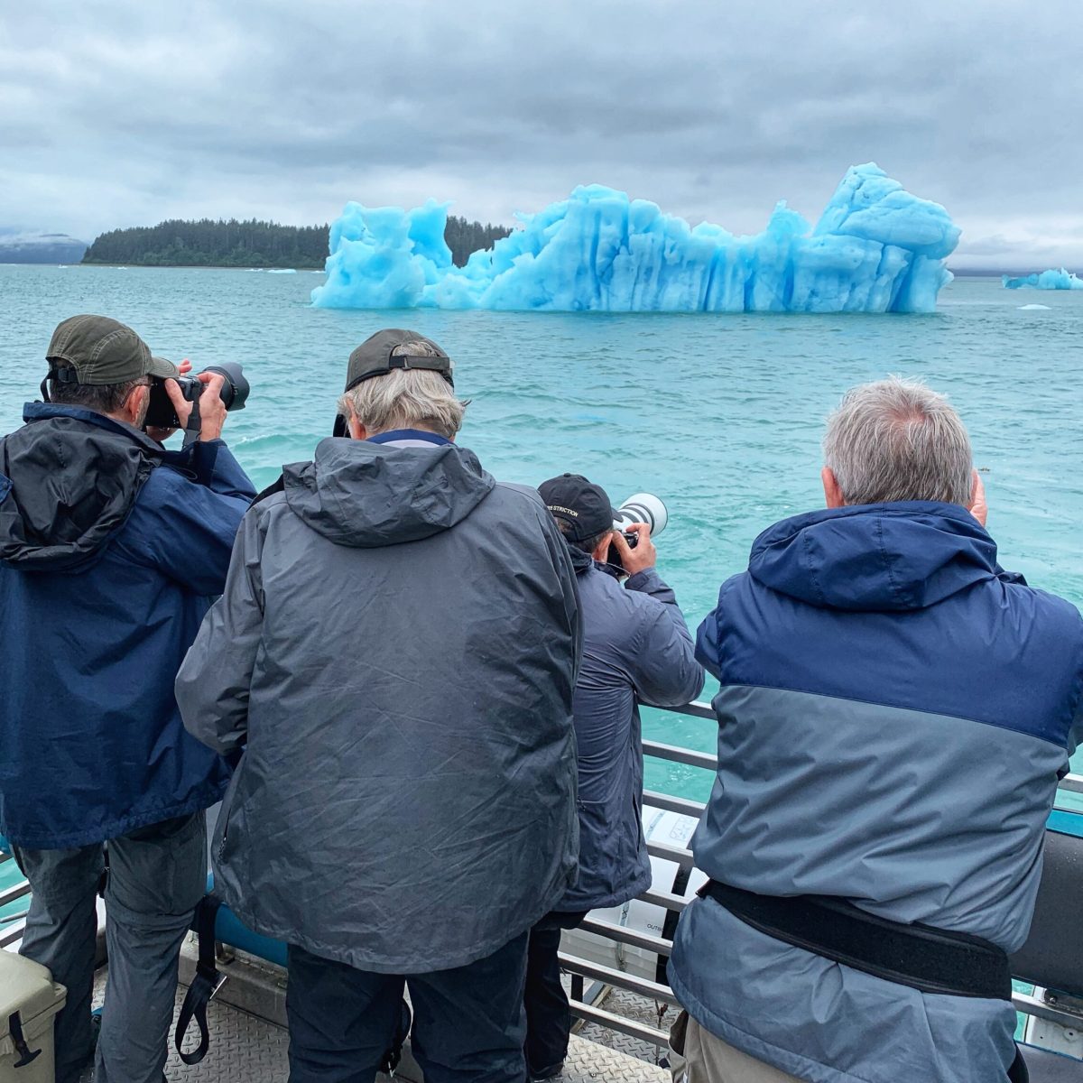 a group of people standing next to a body of water
