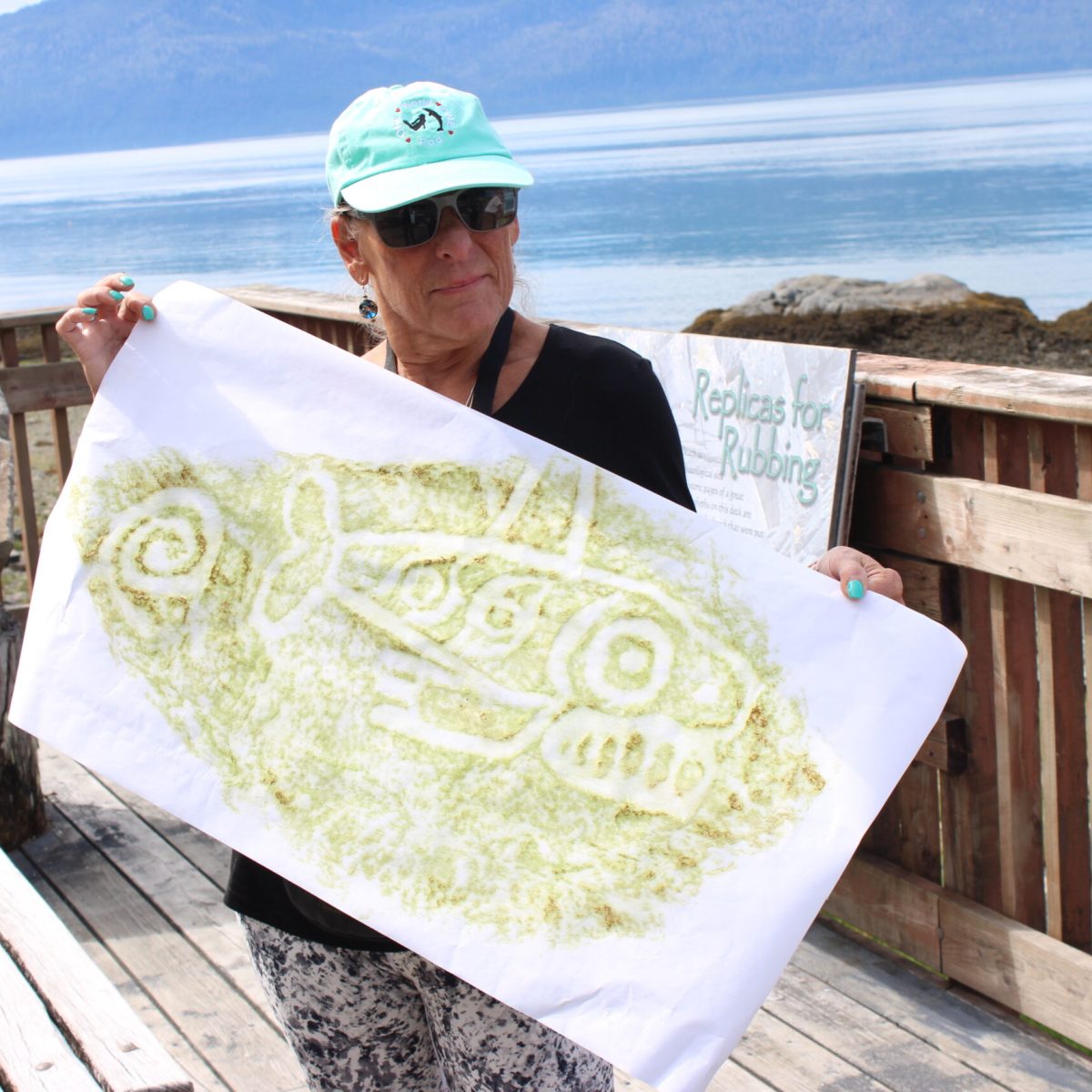 a person sitting on a wooden bench in front of a body of water