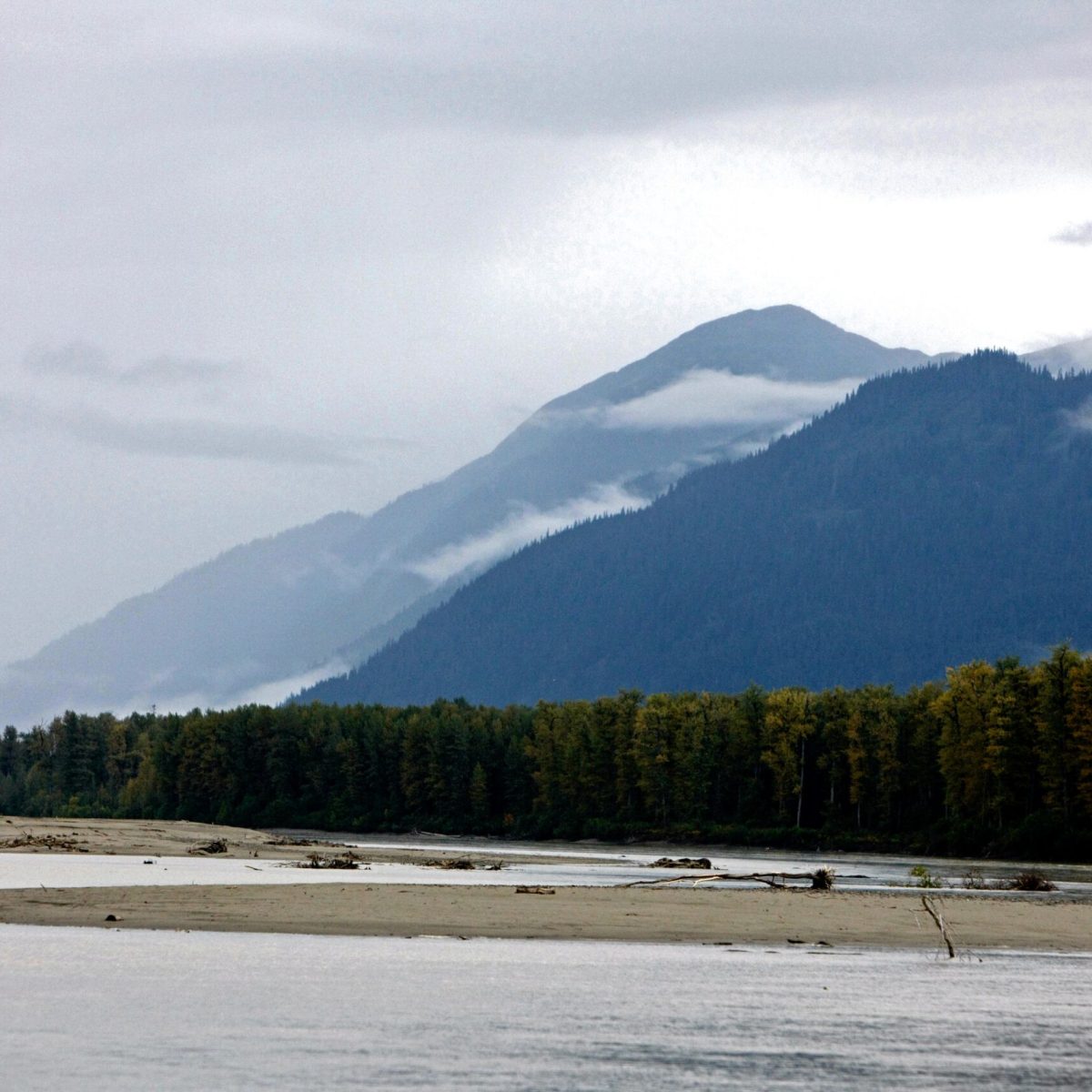 a body of water with a mountain in the background