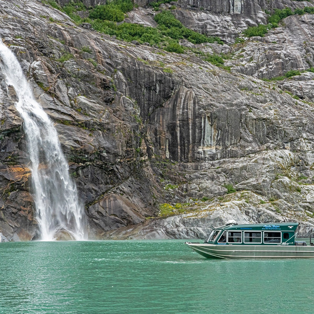 a large waterfall over some water